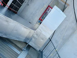 Rooftop insulated ductwork near grating